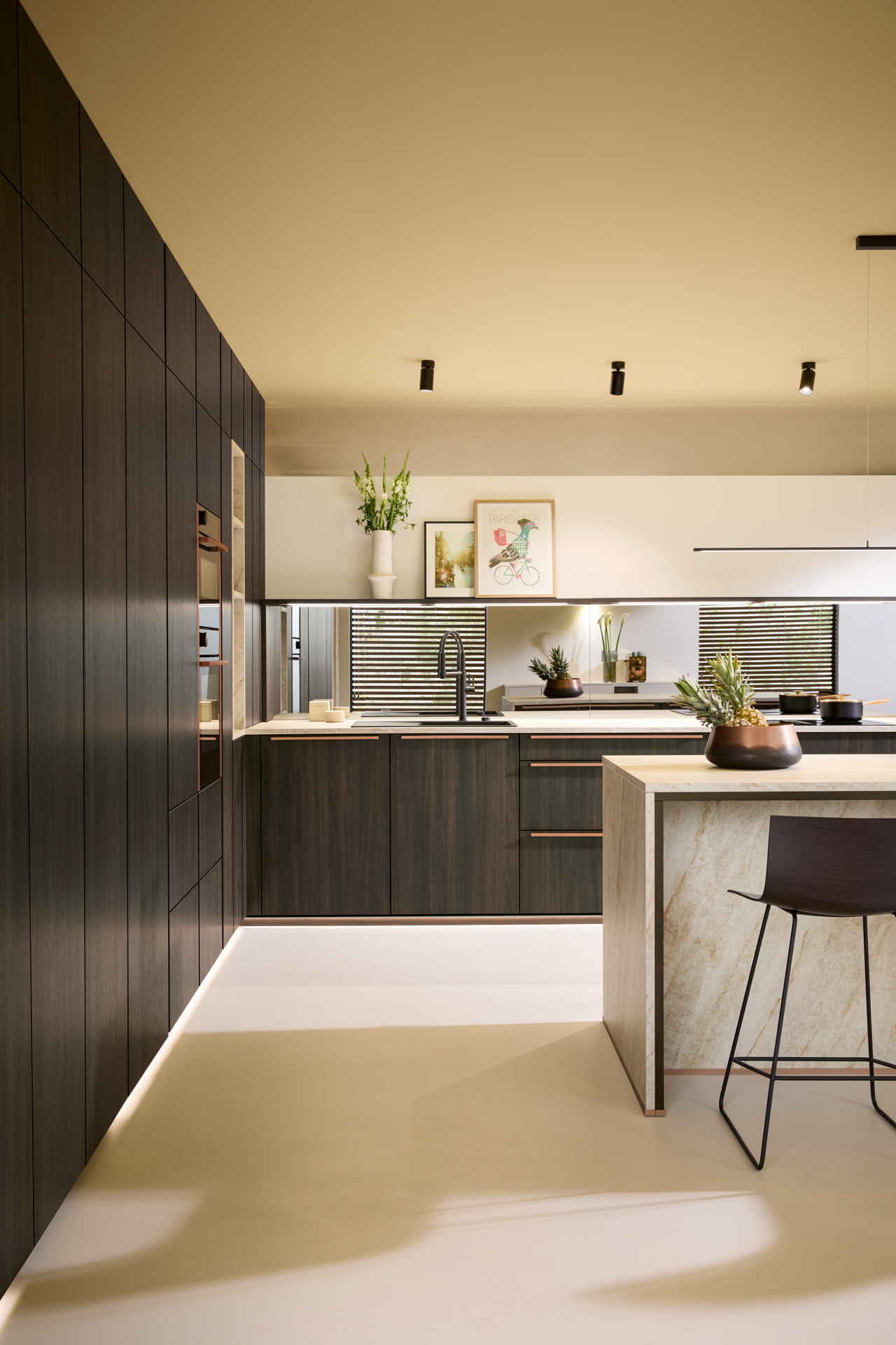 Illuminated kitchen island with seating in an evening-lit room