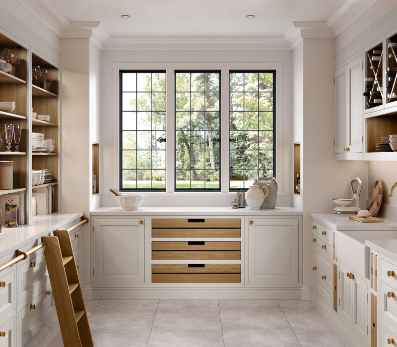 Novelle painted in-frame pantry with oak drawer fronts and open shelving either side of a garden window